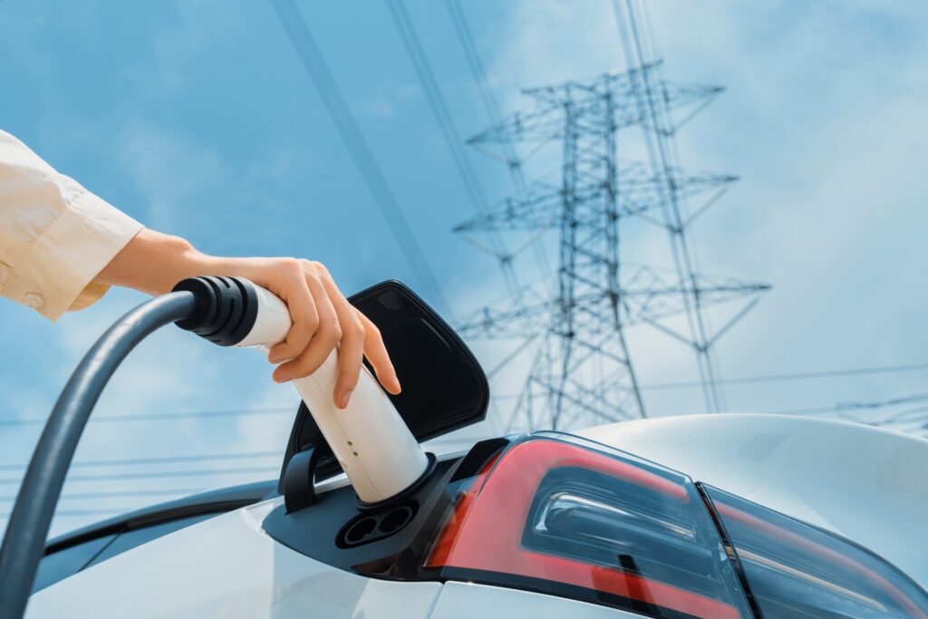 Alternative energy woman recharging electric car power